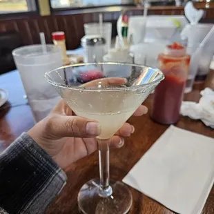 a hand holding a martini