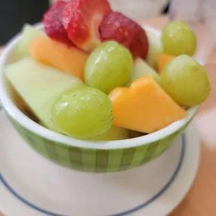 a bowl of fruit on a plate