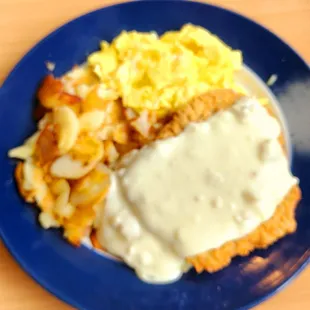 a plate of food with gravy and potatoes