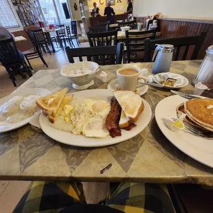 a breakfast of eggs, bacon, and pancakes