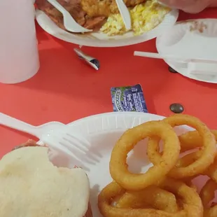 Ham biscuit and onion rings. Ham platter with scrambled eggs, hash browns, and 2 biscuits.