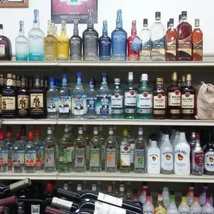 a shelf full of liquor bottles