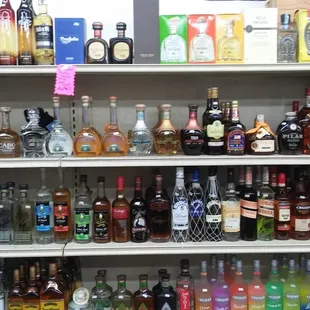 a shelf full of liquor bottles