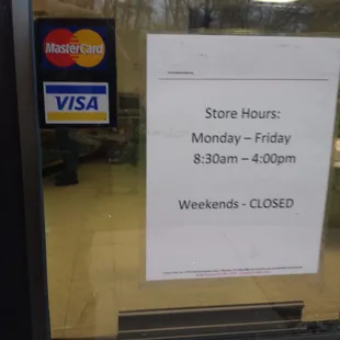 a store hours sign in a window