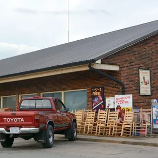 a red truck parked in front of a store