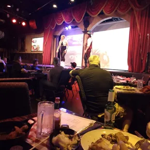 a man standing on stage in front of a crowd