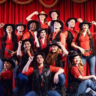 a group of performers posing for a picture