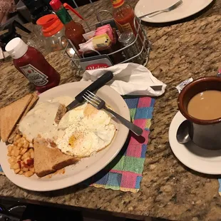 a plate of eggs, toast, and coffee