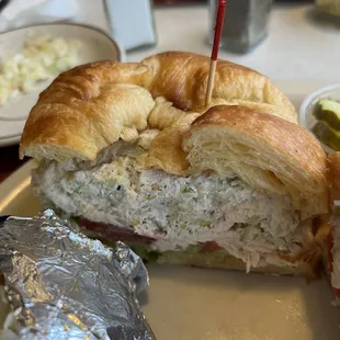 a chicken salad sandwich on a croissant roll