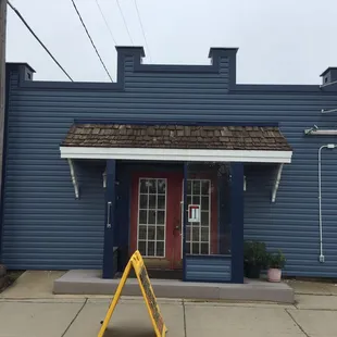 a blue building with a red door