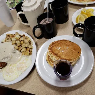 a breakfast of pancakes, hash browns, and eggs