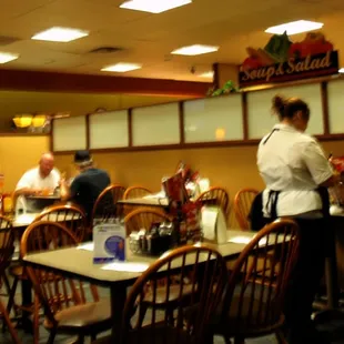 people sitting at tables in a restaurant