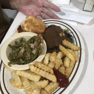 Hamburger Steak with gravy, fries and green beans.