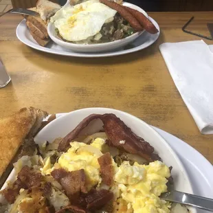 a plate of eggs, hash browns and toast