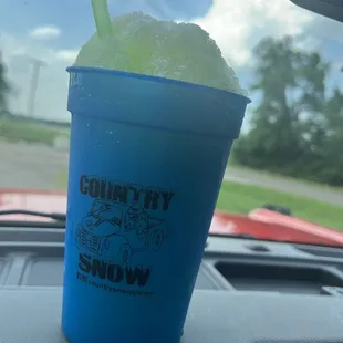 a blue cup with a green straw