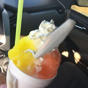 a hand holding a cup of frozen fruit