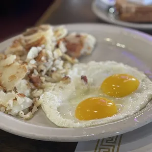 a plate of eggs and hash browns