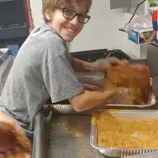 The oldest King boy loves his new job of injecting and rubbing the meat before it gets put into the huge smoker.