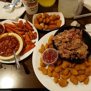 Barbeque and popcorn shrimp, sweet potato fries, baked beans and hush puppies.