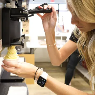 a woman making an ice cream cone