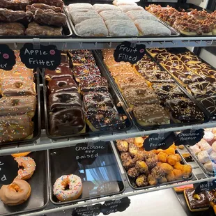 a variety of donuts in a display case