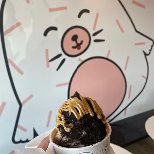 Custard twist with oreo crumbles and peanut butter drizzle.