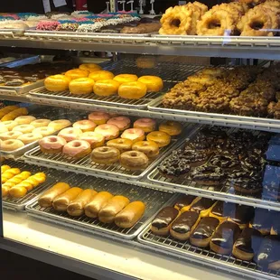 a variety of donuts in a display case