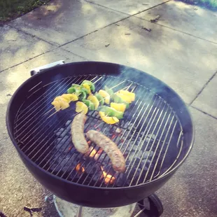 sausages and peppers on a grill