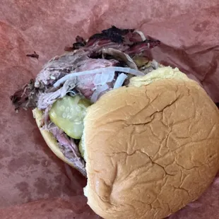 Pulled pork sandwich with pickles and onions. The bun just melts in your mouth. There is no better sandwich.