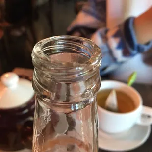 Glass bottle with cracked rim and glass pieces in bottle