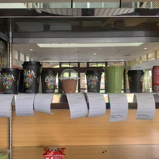 a row of coffee cups on display