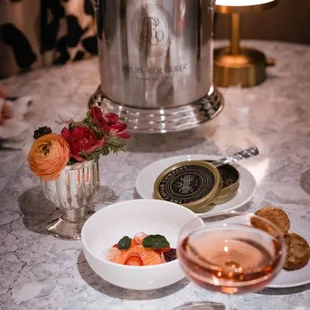 a table with champagne, crackers, and a bottle of wine