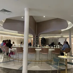 people sitting at tables in a restaurant