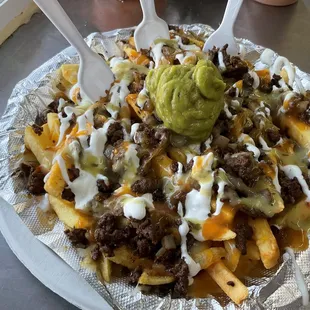 a plate of nachos with guacamole