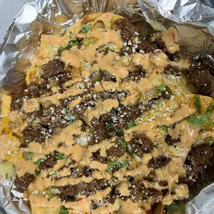 a plate of nachos covered in sauce