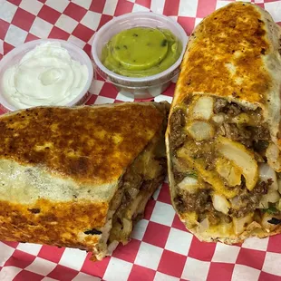 a burrito cut in half with a side of guacamole
