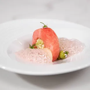 a plate of food with a watermelon garnish