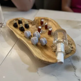 a wooden plate with a variety of food items on it