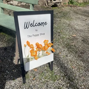 Welcome sign outside The Poppy Shop