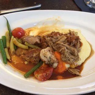 Pan roasted game hen served with polenta and fresh veggies