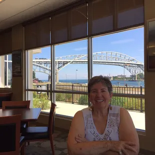 My neighbor who was carded with the view of the Blue Water Bridge in the background.