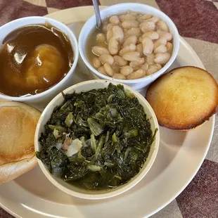 Vegetarian plate, 3 sides Green turnip, mashed potatoes with brown gravy, white beans, cornbread, and a piece of bread loaf .