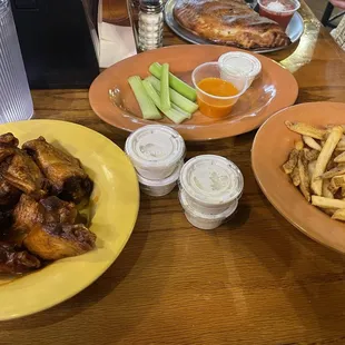 Mild wings with a side of fries.