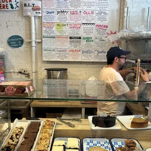Sandwich board background and baked items under glass.
