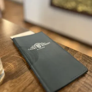 Love the detail... check book with the blue leather and restaurant&apos;s logo.