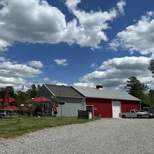 a red barn and a white truck