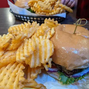 Cheeseburger with lettuce, onion, and tomato with fries