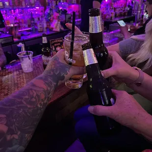 two people clinking glasses of beer