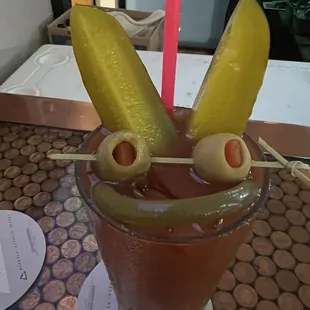 a bloody drink with olives and pickles
