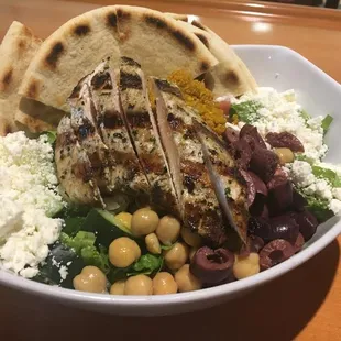 Fresh and flavorful Mediterranean Salad.  Grilled Chicken, feta cheese, kalamata olives, quinoa, chickpeas, tomato, and cucumber.